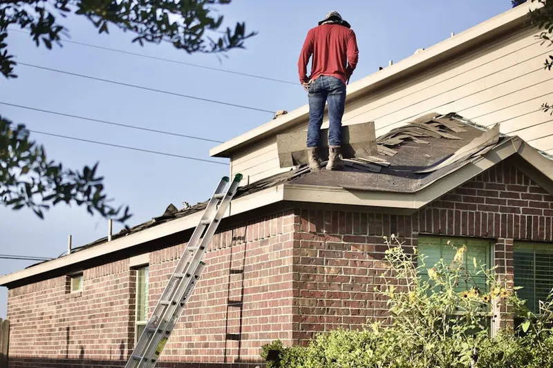 Professional roofer working on a residential roof in Pleasant Shadows